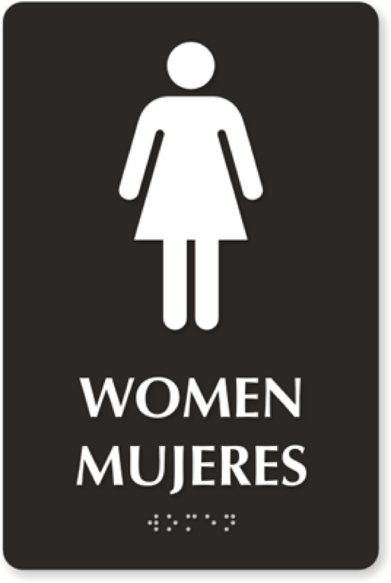 A bathroom sign that indicates gender in multiple languages. In English, it says “Women.” In Spanish, it says “Mujeres.” The information is also replicated in braille. Above these is a pictogram of a woman.